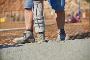 Medford concrete worker pouring fresh concrete.