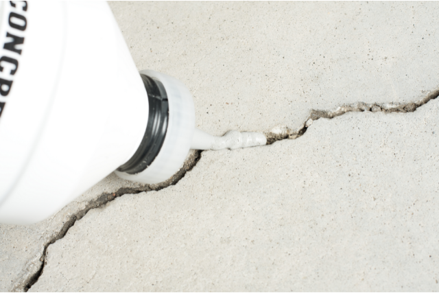 Medford worker filling a concrete crack
